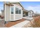 Rear exterior view of home featuring outdoor patio and large windows at 7268 Greenwater Cir, Castle Rock, CO 80108