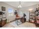 Home office with a dark desk, lots of books, and a map of the USA on the wall at 7268 Greenwater Cir, Castle Rock, CO 80108