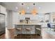 Modern kitchen with a large island, stainless steel appliances, and pendant lighting at 7268 Greenwater Cir, Castle Rock, CO 80108