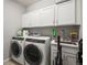 Laundry room with washer, dryer, sink and storage cabinets at 7268 Greenwater Cir, Castle Rock, CO 80108