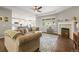 Open-concept living room boasts a fireplace, hardwood floors, and abundant natural light at 7268 Greenwater Cir, Castle Rock, CO 80108