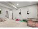 Living room with recessed lights, light grey carpet, and colorful toys at 7268 Greenwater Cir, Castle Rock, CO 80108