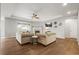 Bright living area with tray ceiling, hardwood floors, fireplace, and large window at 7268 Greenwater Cir, Castle Rock, CO 80108