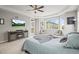 Main bedroom with a gray fireplace console, large bay window, and soft, neutral decor at 7268 Greenwater Cir, Castle Rock, CO 80108