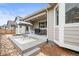 Covered patio with outdoor seating, grill, and a view of the landscaped backyard at 7268 Greenwater Cir, Castle Rock, CO 80108