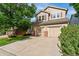 Charming two-story home with a well-maintained lawn, mature tree and a two car garage at 13486 Clayton St, Thornton, CO 80241