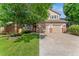 Charming two-story home with a well-maintained lawn, mature tree and a two car garage at 13486 Clayton St, Thornton, CO 80241