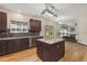 Modern kitchen with brown cabinets, granite counters, stainless steel appliances and hardwood floors at 13486 Clayton St, Thornton, CO 80241