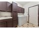 Functional laundry room with ample storage and a convenient sink at 13486 Clayton St, Thornton, CO 80241