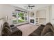 Comfortable living room featuring a fireplace and views of the green backyard at 13486 Clayton St, Thornton, CO 80241