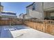 Snow-covered backyard with wooden fence at 16630 E Virginia Ave, Aurora, CO 80017