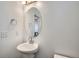 Clean bathroom with single sink vanity, and oval mirror at 16630 E Virginia Ave, Aurora, CO 80017