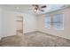 Bright bedroom featuring ceiling fan, carpet, and walk-in closet at 16630 E Virginia Ave, Aurora, CO 80017