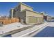 Two-car garage with driveway and snow at 16630 E Virginia Ave, Aurora, CO 80017