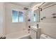 Bright bathroom with updated sink, fixtures, and a glass shelf at 1701 Kingston St, Aurora, CO 80010