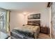 Cozy bedroom featuring rustic wood accents and a picture of a forest above the bed at 1701 Kingston St, Aurora, CO 80010