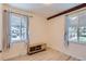 Bedroom with hardwood floors, a wood accent beam, and a simple wood console at 1701 Kingston St, Aurora, CO 80010