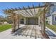 Covered carport featuring a vine-covered pergola, providing shaded parking at 1701 Kingston St, Aurora, CO 80010