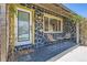 Inviting front porch with chairs, showcasing a stone facade and yellow trim at 1701 Kingston St, Aurora, CO 80010