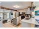 Bright kitchen featuring white cabinets, stainless steel appliances, and an island with seating at 1701 Kingston St, Aurora, CO 80010