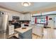 Well-lit kitchen showcasing white cabinetry, stainless steel appliances, and an open layout at 1701 Kingston St, Aurora, CO 80010