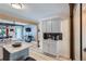 Modern kitchen featuring sleek cabinets, stainless steel appliances, and adjacent seating area at 1701 Kingston St, Aurora, CO 80010