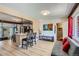 Open-concept living room with hardwood floors, a modern sofa, and seamless kitchen access at 1701 Kingston St, Aurora, CO 80010