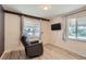 Light-filled living room with hardwood floors, neutral walls, and a comfortable recliner at 1701 Kingston St, Aurora, CO 80010