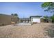 Exterior view of a backyard with a sunroom, patio, pergola, and minimal landscaping at 1020 Kipling St, Lakewood, CO 80215