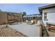 Backyard features a sunroom, gray patio, and wooden pergola, perfect for outdoor entertaining at 1020 Kipling St, Lakewood, CO 80215
