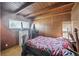 Comfortable bedroom featuring natural light, wood paneling, a wooden ceiling and dresser at 1020 Kipling St, Lakewood, CO 80215