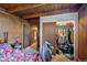 Bedroom with wood paneling and closet with various items at 1020 Kipling St, Lakewood, CO 80215