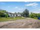 Quaint single-story home with a flat roof and long driveway with two vehicles parked on the lot at 1020 Kipling St, Lakewood, CO 80215