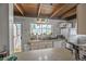 Well-lit kitchen with a window overlooking an adjacent living area and equipped with white appliances at 1020 Kipling St, Lakewood, CO 80215