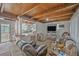 Spacious living room with a wooden ceiling, open layout and an adjacent kitchen with a breakfast bar at 1020 Kipling St, Lakewood, CO 80215