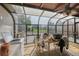 Light-filled sunroom with glass enclosure, ceiling fan, and outdoor access, offering a bright living space at 1020 Kipling St, Lakewood, CO 80215