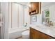 This bathroom includes a shower over the tub and updated vanity at 1703 S Grant S St, Denver, CO 80210