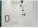 This updated bathroom features a walk-in shower with tile surround and bronze fixtures at 1703 S Grant S St, Denver, CO 80210