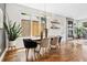 Open floor plan with a dining room that features a modern chandelier and hardwood floors at 1703 S Grant S St, Denver, CO 80210