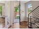 Inviting entryway featuring an open door and gleaming hardwood floors, leading to the staircase at 1703 S Grant S St, Denver, CO 80210