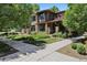 Beautiful two-story home with stone accents and a well-manicured front yard and sidewalk at 1703 S Grant S St, Denver, CO 80210