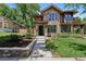 Charming stone front exterior with meticulously landscaped yard and inviting entryway at 1703 S Grant S St, Denver, CO 80210