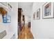 Hallway featuring hardwood floors, built-in shelving, and access to the kitchen at 1703 S Grant S St, Denver, CO 80210