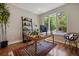 Bright home office with large window, hardwood floors, ladder bookshelf, and modern desk at 1703 S Grant S St, Denver, CO 80210