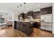 Modern kitchen featuring stainless steel appliances, island with seating, and open layout at 1703 S Grant S St, Denver, CO 80210