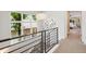 Top of the stairs with views out of a large window, and an open hallway to the bedrooms at 1703 S Grant S St, Denver, CO 80210