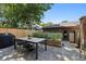 Exterior patio with table, seating, grill, and surrounding garden beds on a bright sunny day at 1703 S Grant S St, Denver, CO 80210