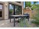Outdoor patio area, perfect for entertaining with dining table, grill, and beautiful flowering plants at 1703 S Grant S St, Denver, CO 80210