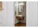 Stylish powder room featuring a floating sink, modern mirror, and sleek design elements at 1703 S Grant S St, Denver, CO 80210