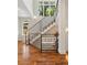 Elegant staircase with contemporary railing and natural light, complements the hardwood floors at 1703 S Grant S St, Denver, CO 80210